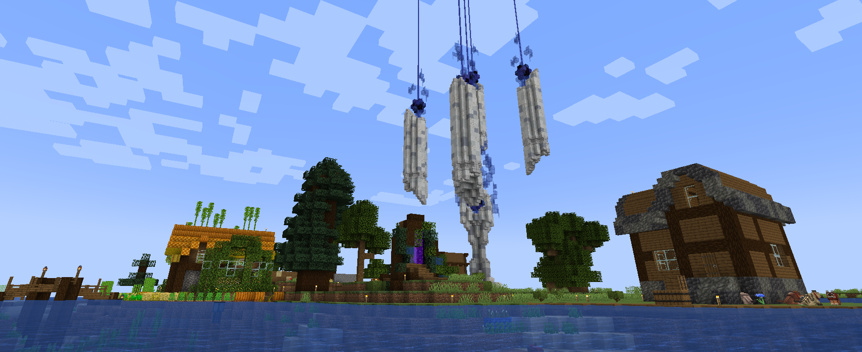 Screenshot of the riverside of the player village. Several houses are visible.